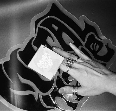 Photoshoot featuring a resin sign made with the Metal Mane logo and the printed brush tag.